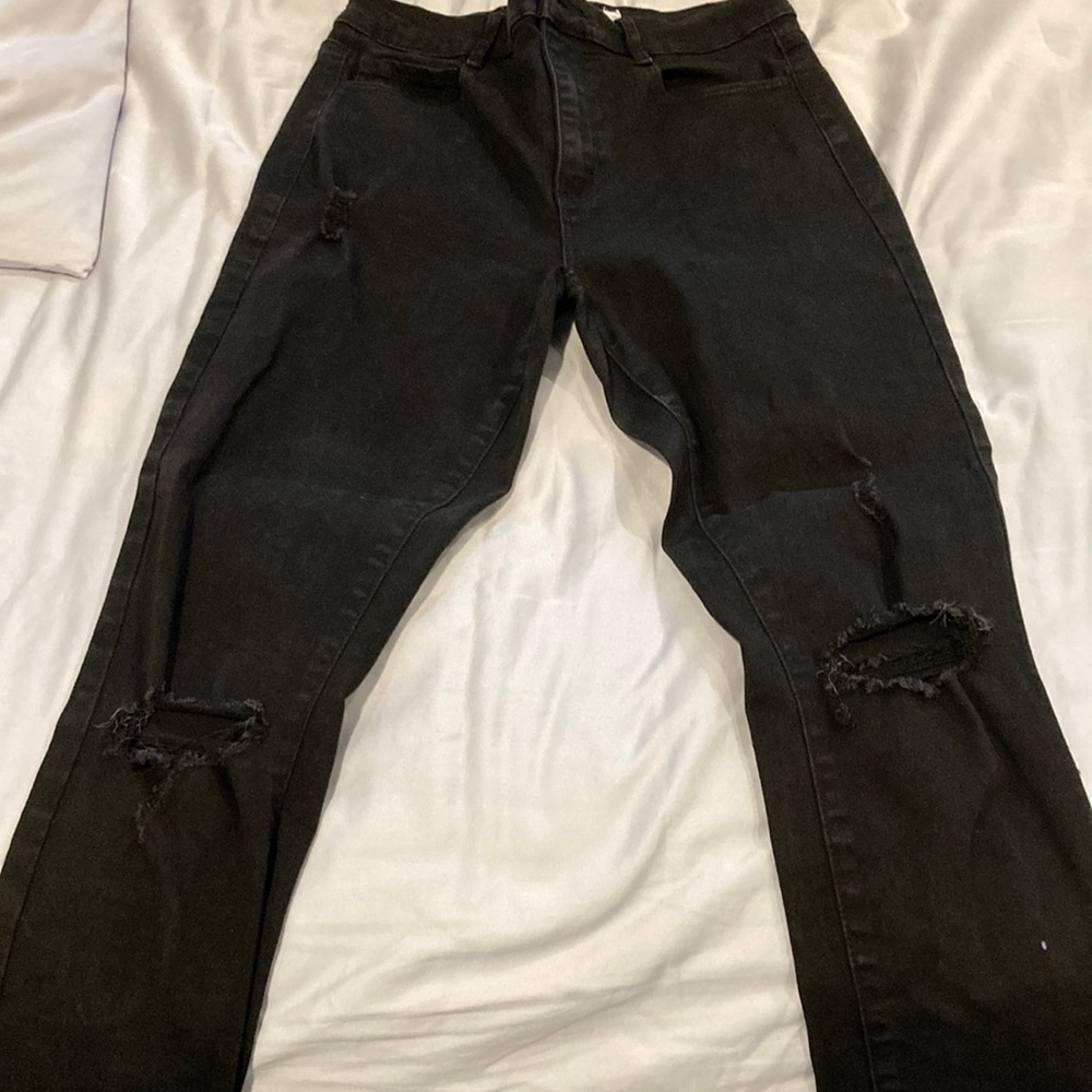 Garage store, black ripped jeans.
